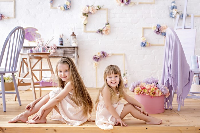 Two little girls sitting and smiling