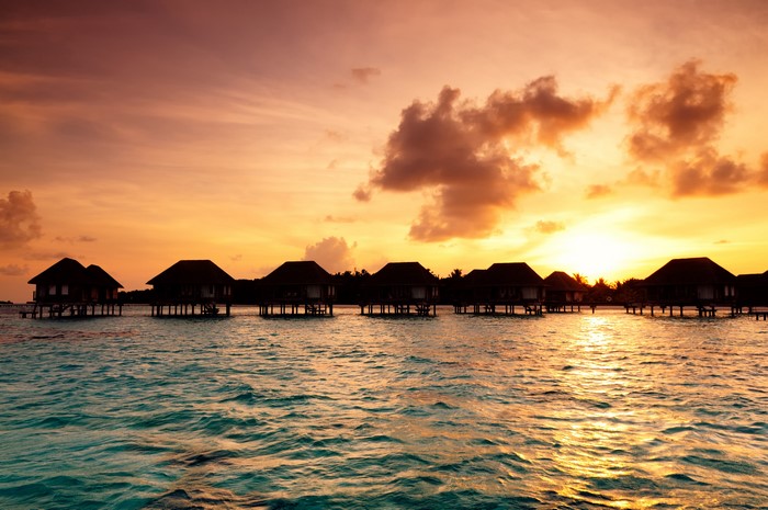 Overwater bungalows at sunset in the Maldives