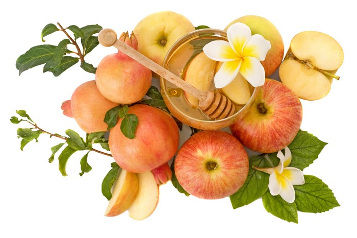 Apples, Pomegranates, Honey, and Plumeria on White Background