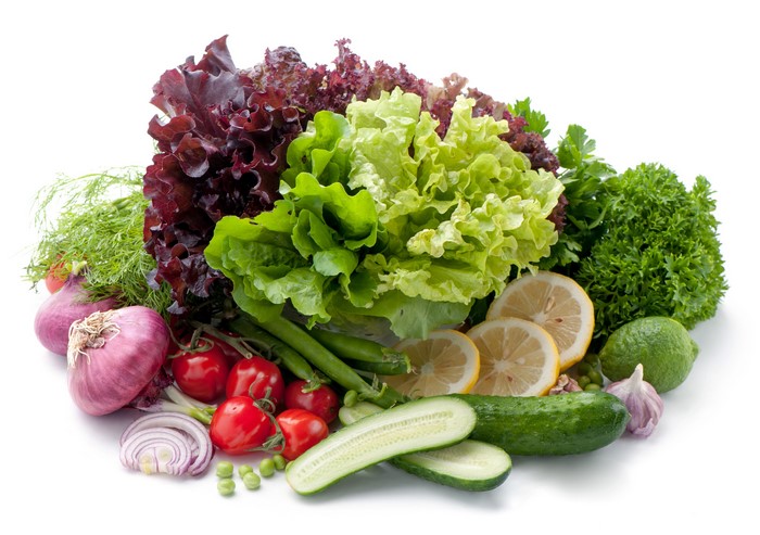 Assortment of fresh vegetables and fruits on a white background