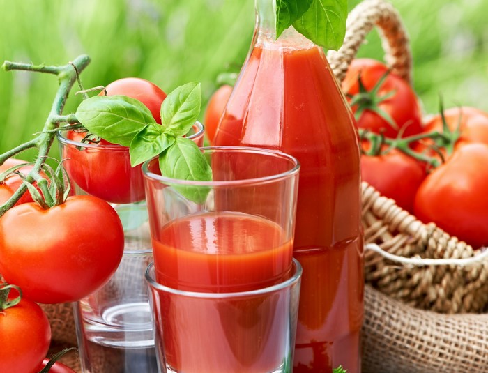 Tomatoes and tomato juice in glasses and bottle