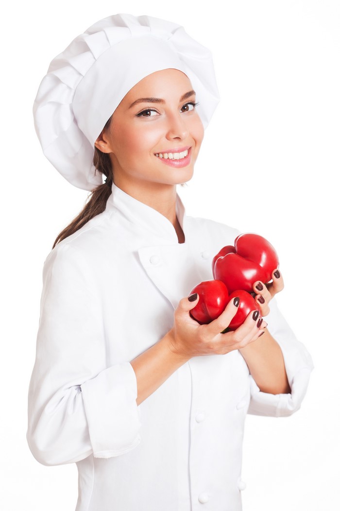 Chef holding red bell peppers