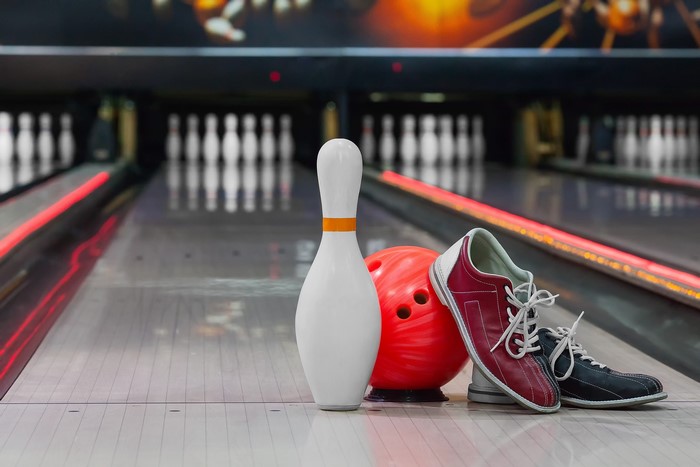 Bowling pin, ball, and shoes on lane