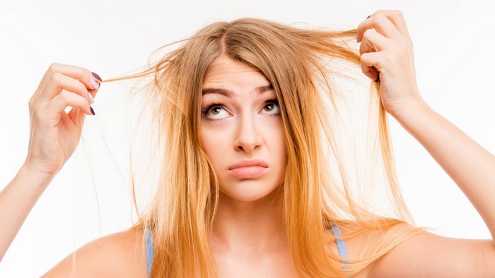 Woman with messy blonde hair looking up