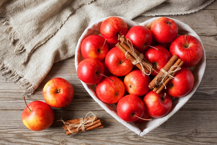 Red Apples and Cinnamon Sticks in Heart Bowl