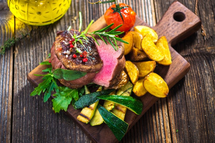Beef steak with roasted potatoes and grilled zucchini