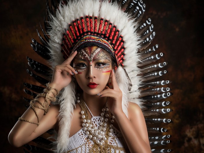 Woman in Native American Headdress with Face Paint