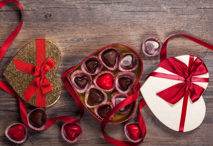 Heart-shaped Valentine's Day chocolate boxes with red ribbon