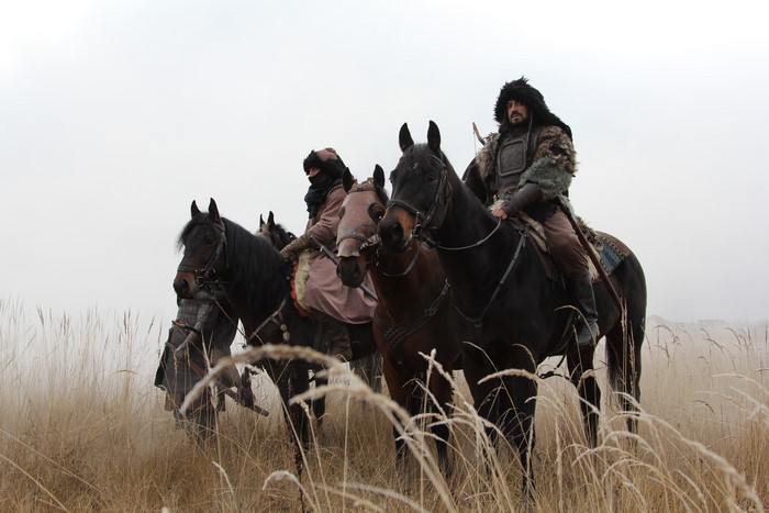 Warriors on horses in a field