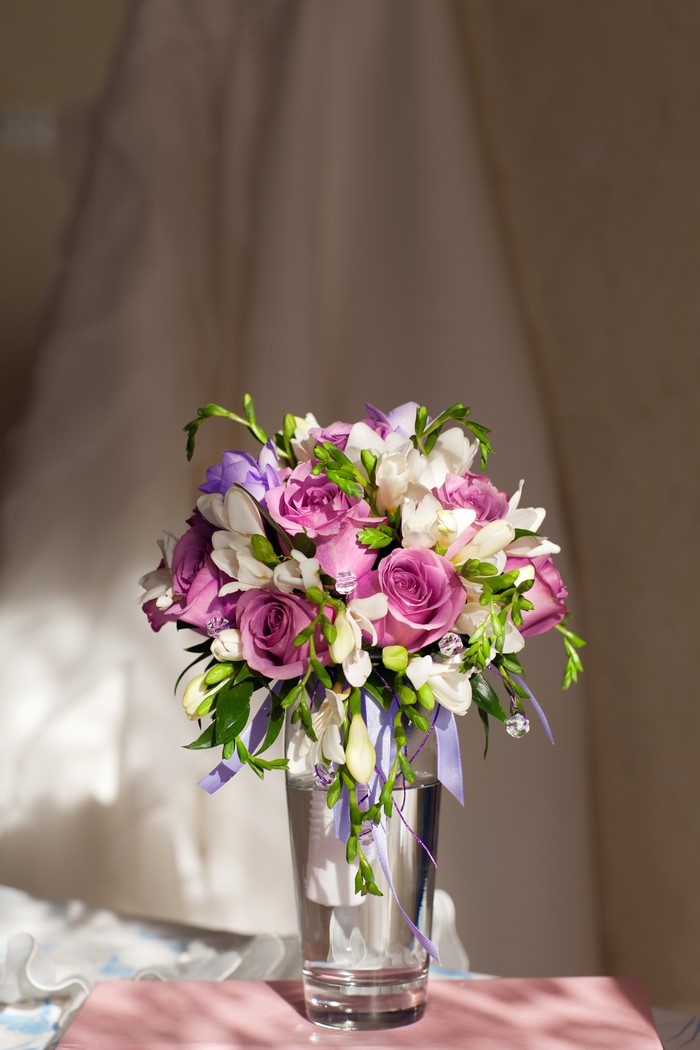 Purple and white flowers in a glass vase