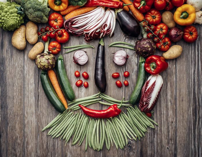 Vegetable face on wood planks