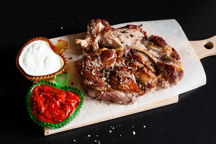 Grilled Meat with Sauces on Cutting Board