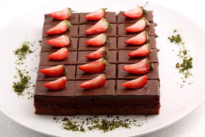 Chocolate cake with strawberries and pistachios