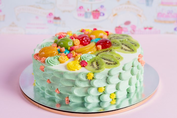 Fruit decorated cake with green frosting