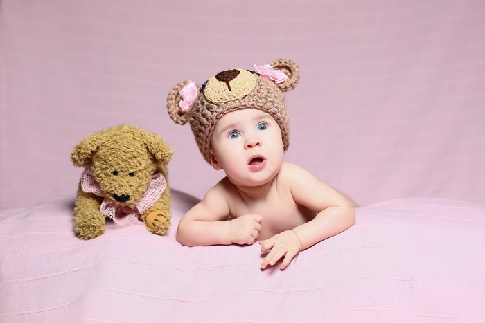Baby in Teddy Bear Hat with Teddy Bear