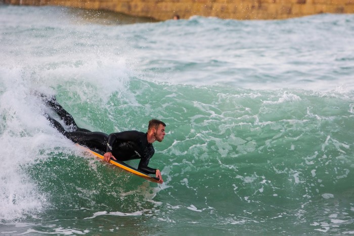 Man bodyboarding on a wave