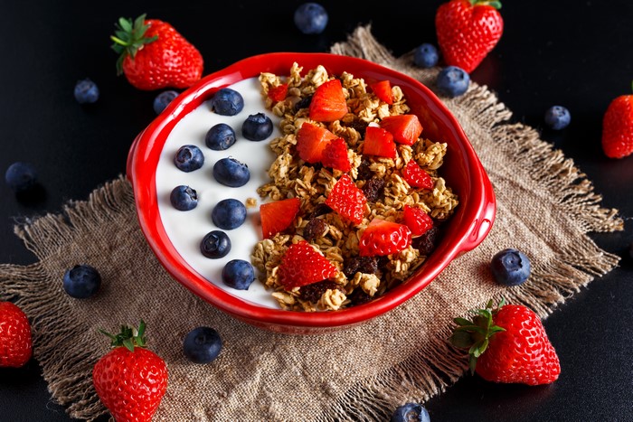 Muesli with Blueberries and Strawberry in a Red Bowl
