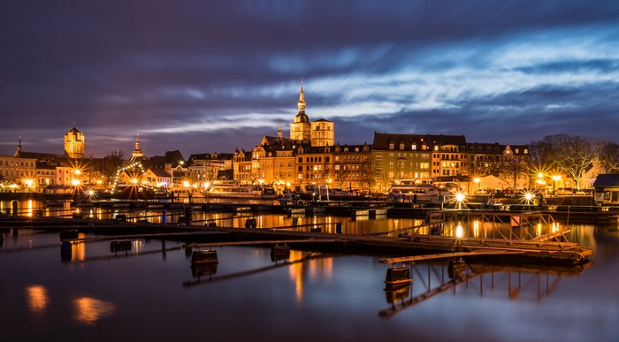 Night view of Stralsund harbor with illuminated buildings