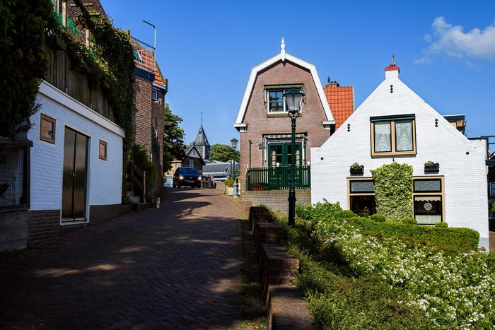 Street in Urk, Netherlands with houses and a car