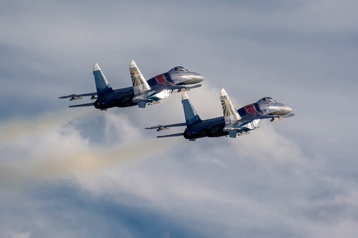 Two Sukhoi Su-30 fighter jets flying in formation