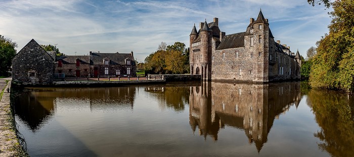 Chateau de Trecesson, a castle surrounded by a pond in France