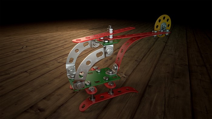 Toy helicopter made of construction set parts on a wooden floor