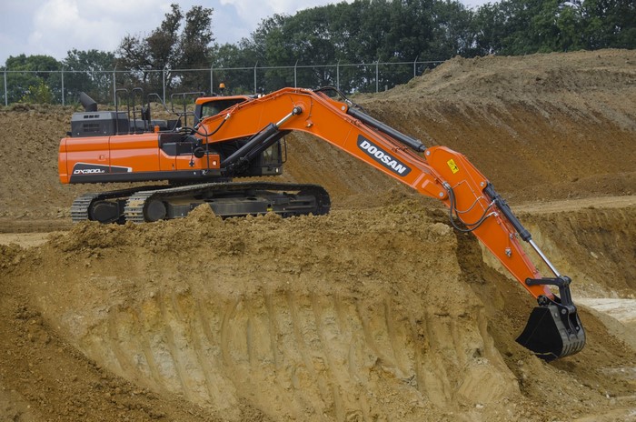 Doosan DX300LC-5 excavator digging in sand