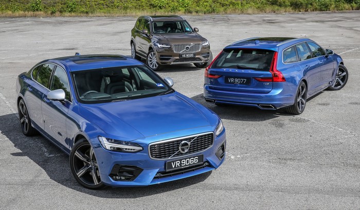 Three Volvo cars parked on asphalt