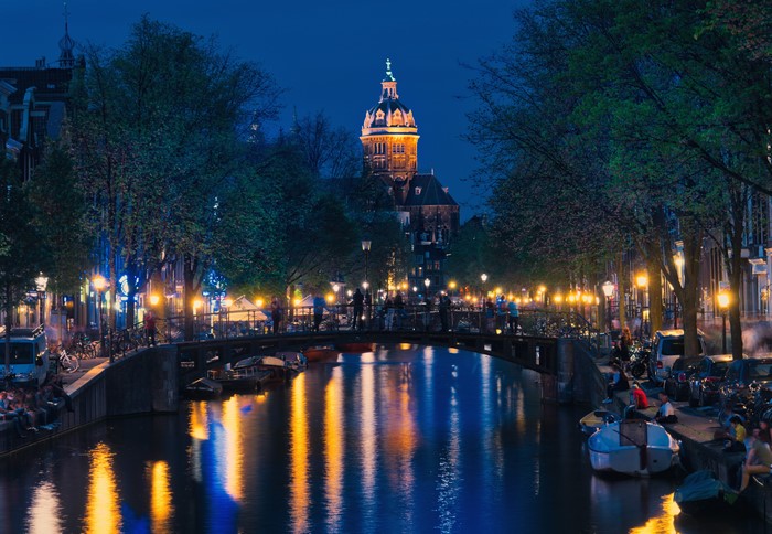 Amsterdam Canal at Night with Bridge and Buildings