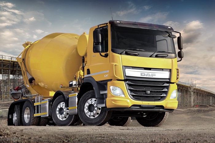 Yellow DAF CF cement mixer truck on construction site