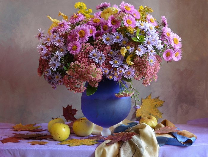 Still-life bouquet of asters and apples in a vase
