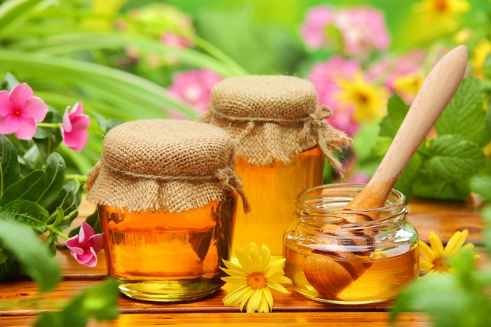 Jars of honey with flowers