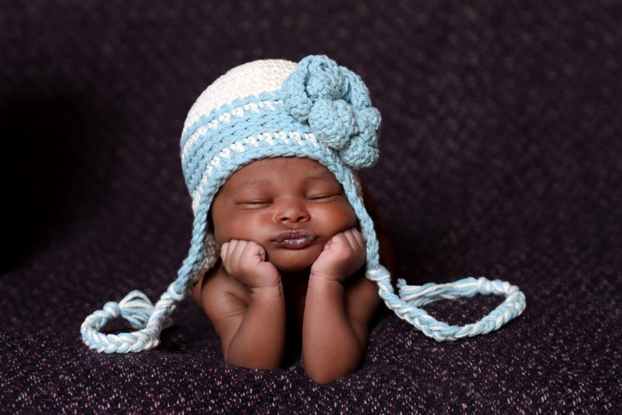 Baby wearing a blue and white knitted hat