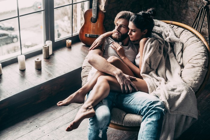 Couple in love sitting in a chair