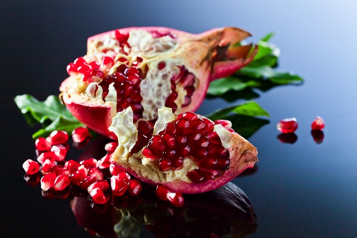 Pomegranate with seeds and leaves