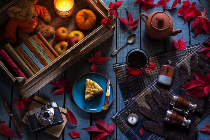 Autumn still life with books, tea, and camera