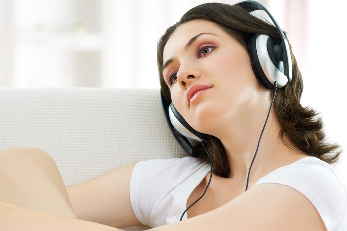 Brown haired woman wearing headphones