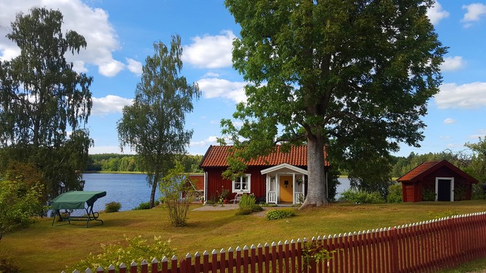 Red house by a lake in Havla, Sweden