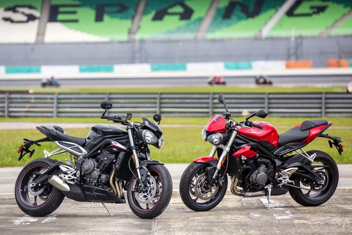Two Triumph Street Triple motorcycles on a racetrack