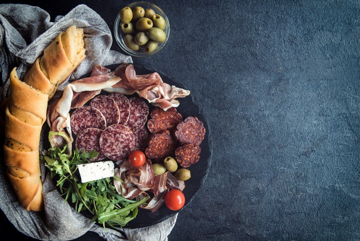 Charcuterie board with bread, olives, and cheese