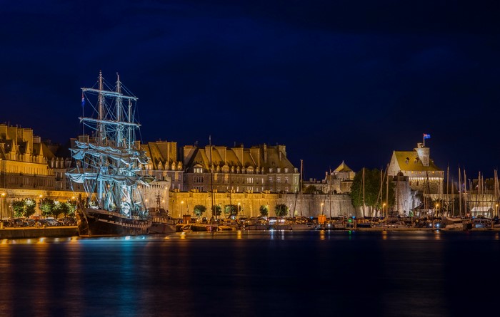 Tall ship docked in Saint-Malo harbor at night