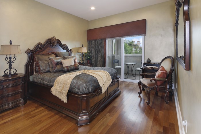 Bedroom with ornate bed and armchair