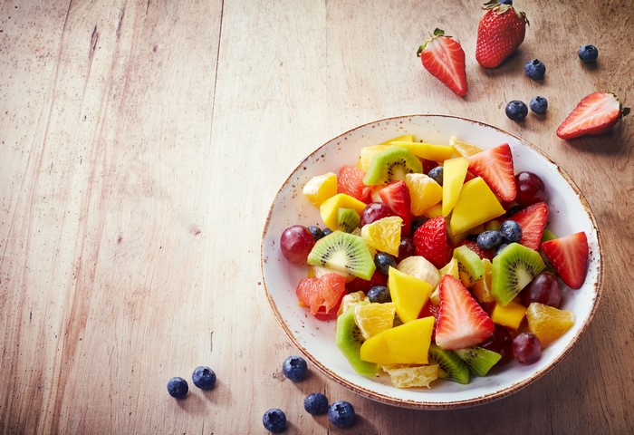 Fruit salad with strawberries and blueberries on wood planks