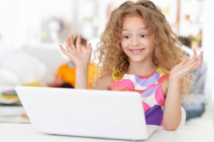 Girl with curly hair using a laptop