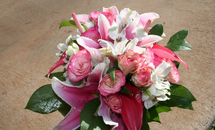 Pink and white flower bouquet with green leaves