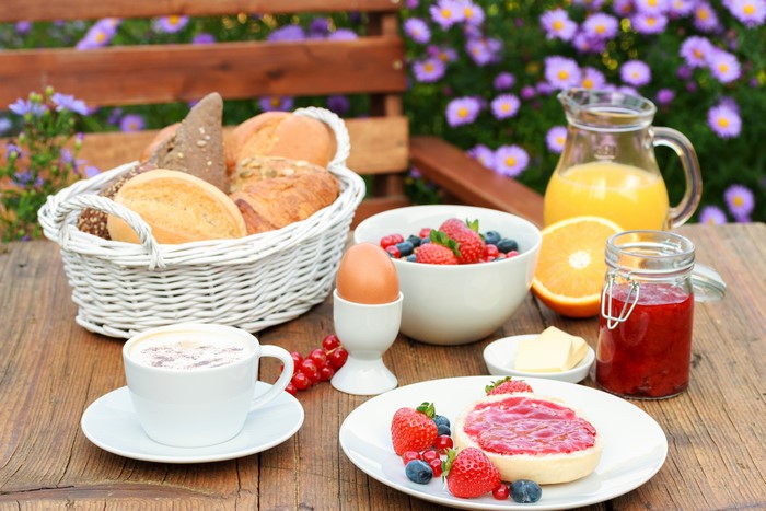 Breakfast with bread, berries, jam, and orange juice