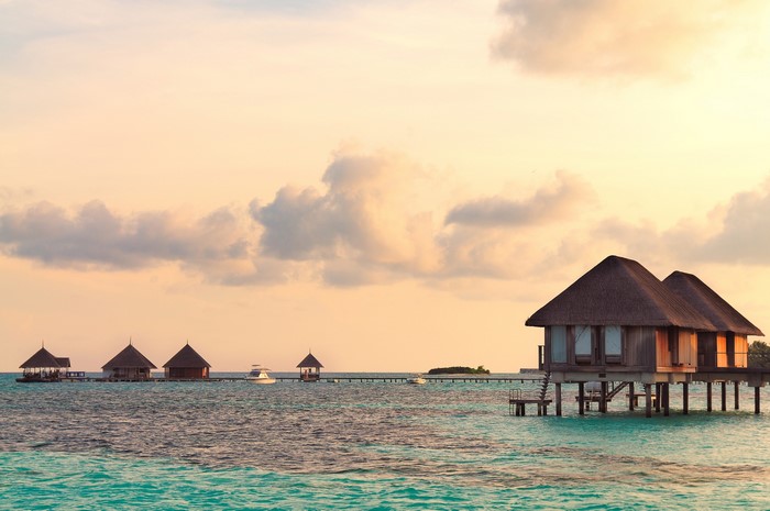 Overwater bungalows at sunset in the Maldives