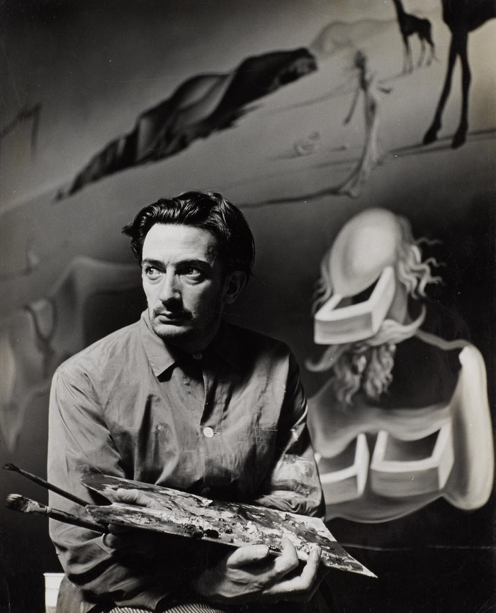 Salvador Dali holding a palette and brushes