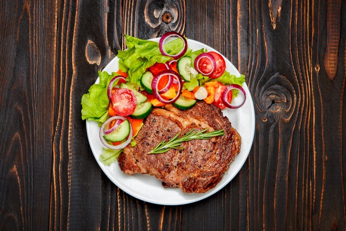 Steak with Salad on a White Plate