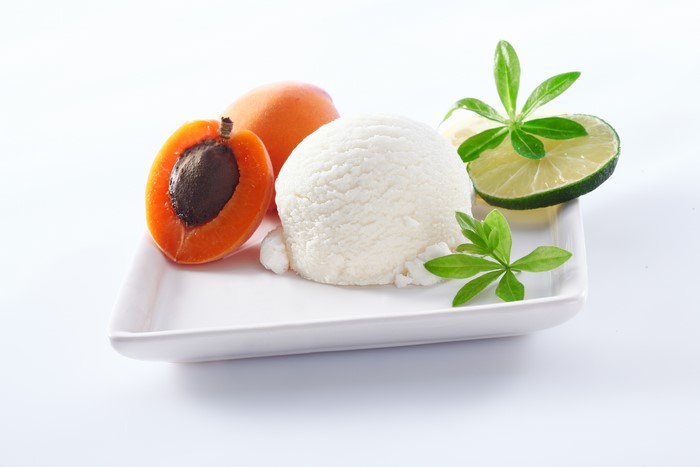 Ice cream scoop with apricots and lime slice
